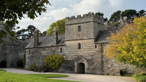 View of the house at Cotehele amongst the autumnal leaves